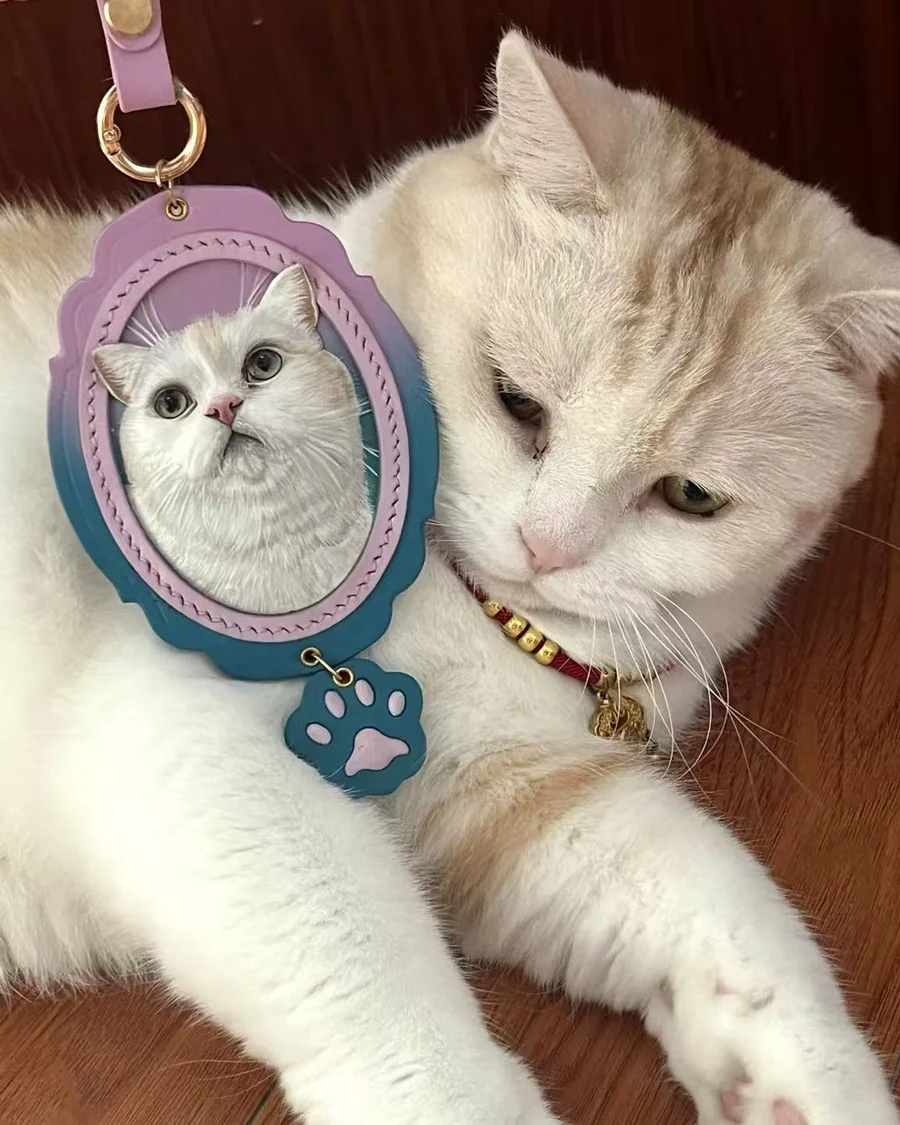 White cat beside its custom scalloped leather portrait